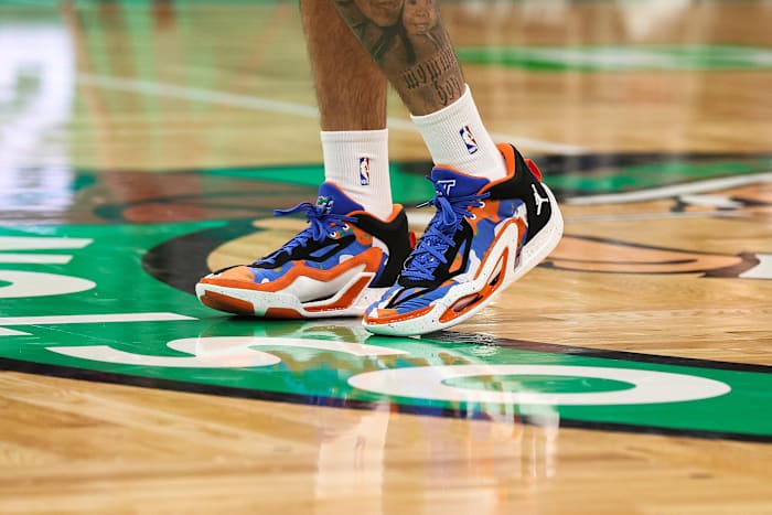 Boston Celtics forward Jayson Tatum's blue and orange Jordan Brand sneakers.
